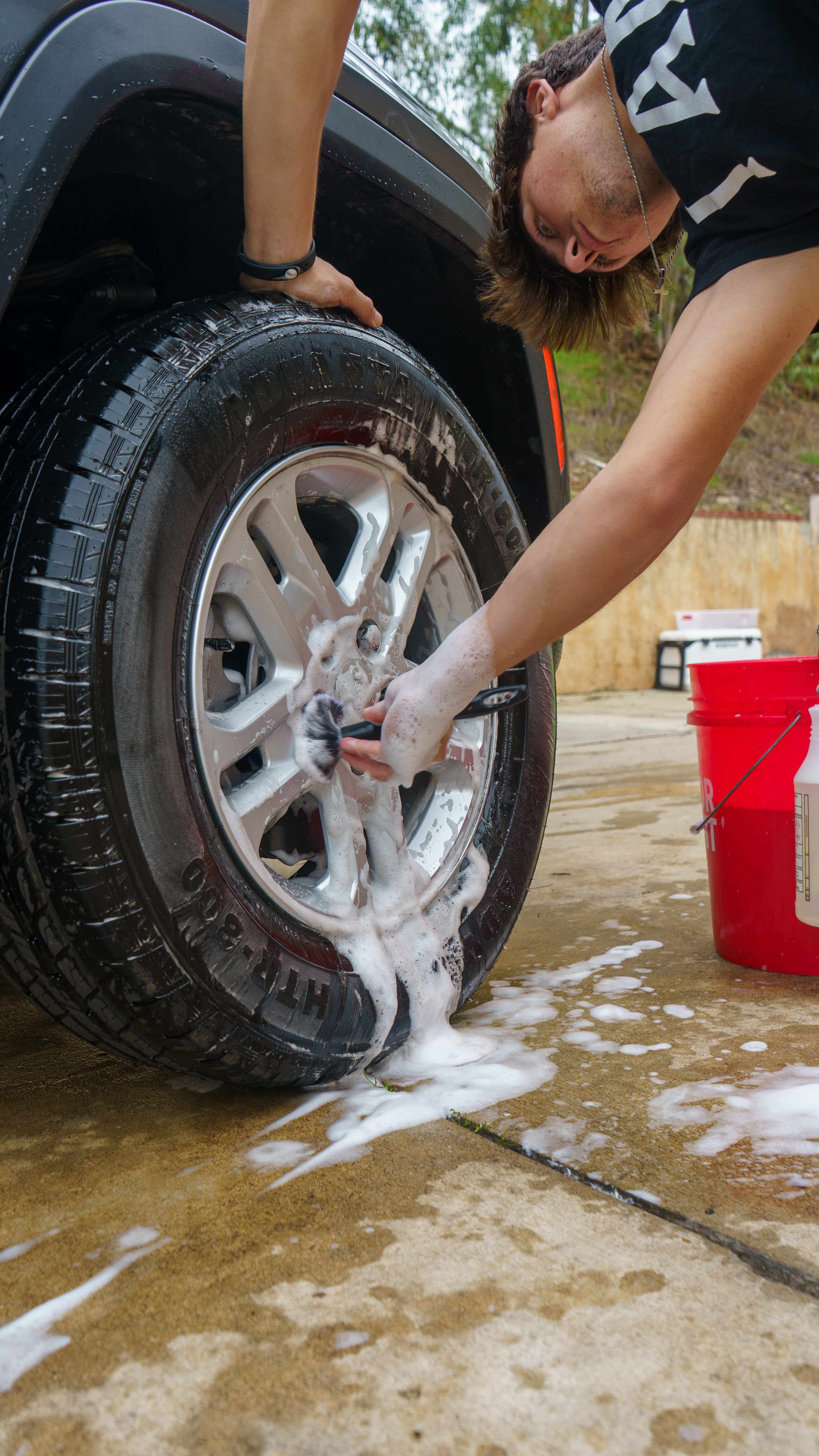 Wheel cleaning in progress with brush and soap
